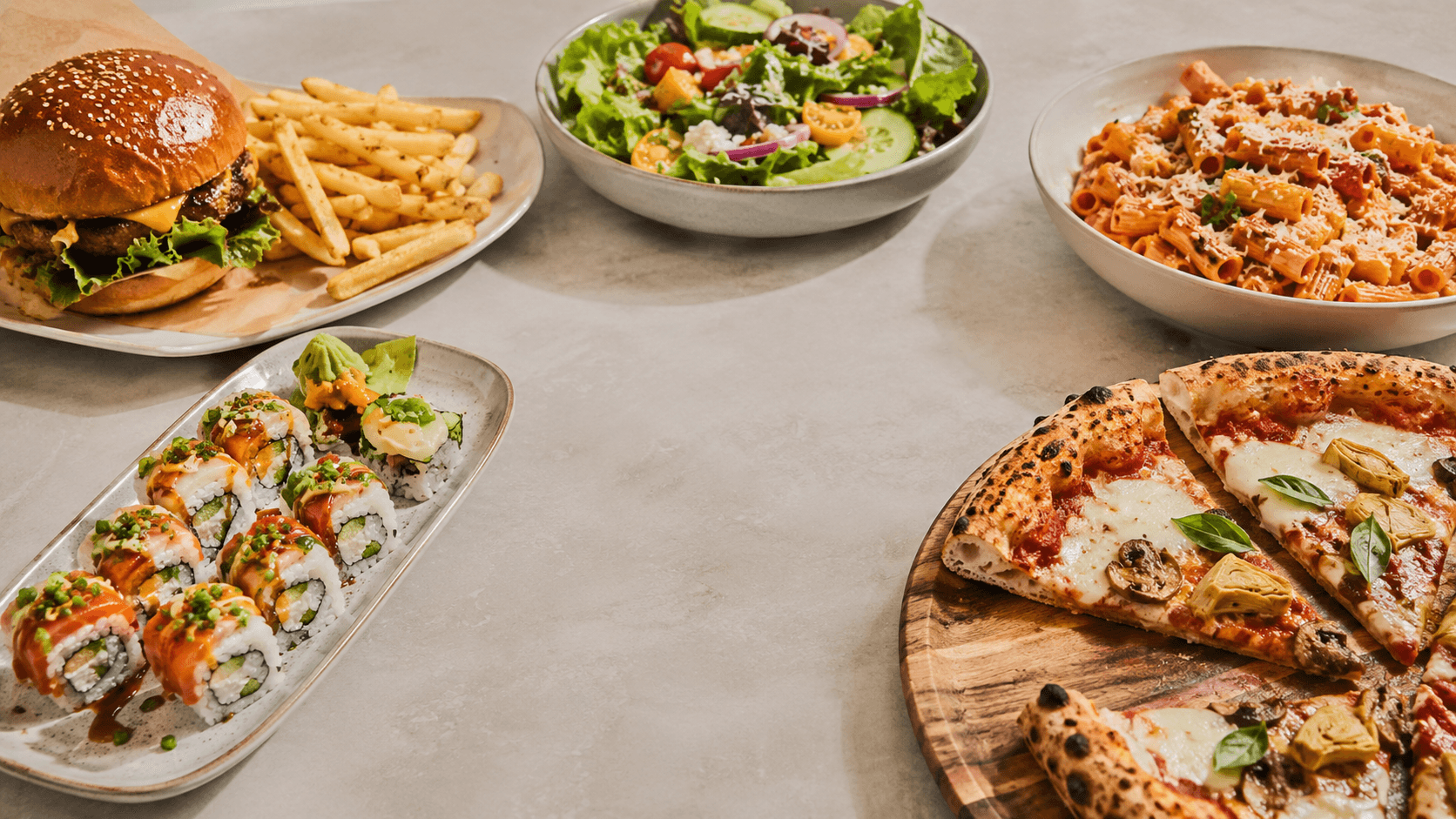 A spread of local dishes — burgers, salad, pasta, sushi and pizza
